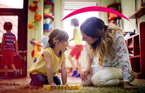 Woman looking into child's mouth.